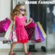 Barbie Fashionistas Barbie girl in a pink dress holding shopping bags